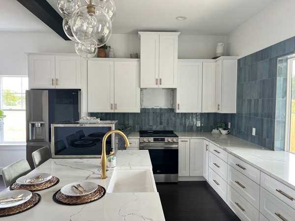 designer kitchen with blue subway tile by WoodArt Cabinets
