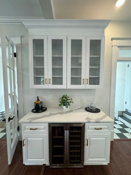 styled bar with quartz waterfall by WoodArt Cabinets
