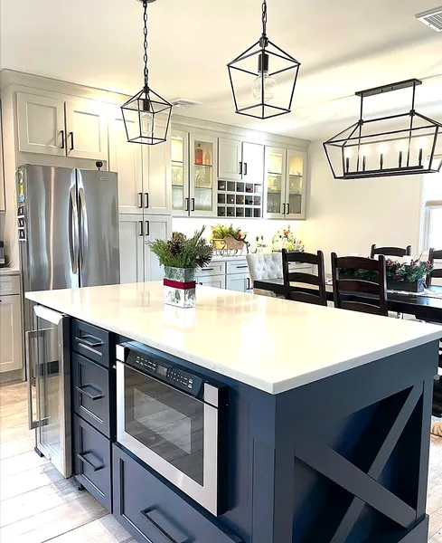 cream kitchen with navy island and lantern pendant lights by WoodArt Cabinets San Antonio