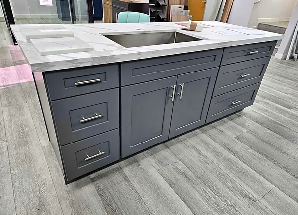 gray shaker island with marble waterfall countertop by WoodArt Cabinets San Antonio