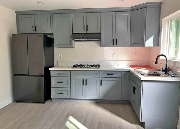 gray shaker kitchen with slate appliances by WoodArt Cabinets San Antonio