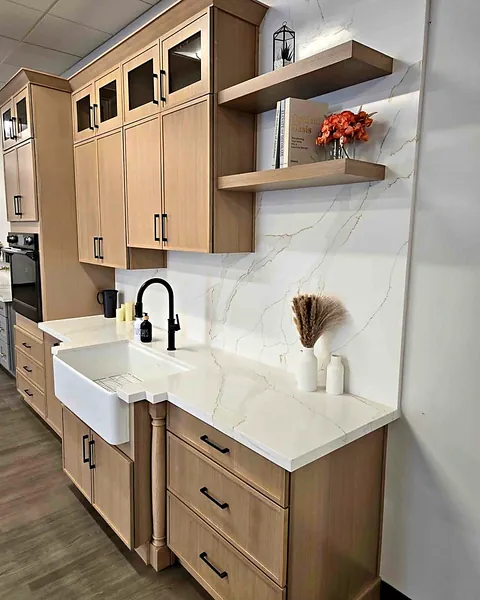 Natural wood kitchen with farmhouse sink and floating shelves by WoodArt Cabinets San Antonio