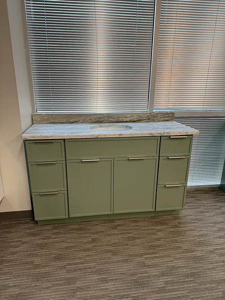 sage green vanity with marble countertop by WoodArt Cabinets San Antonio