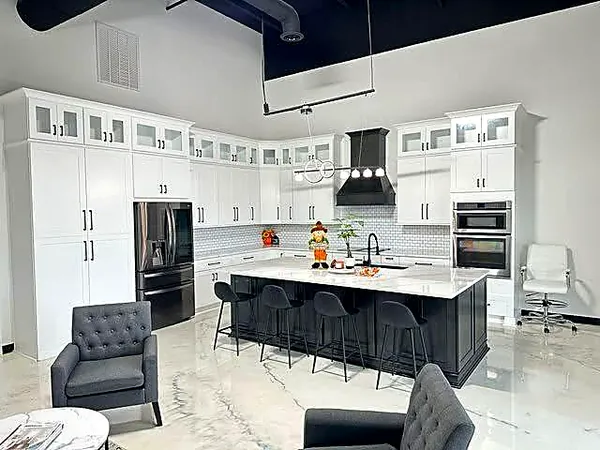 white kitchen with black island and glass upper cabinets by WoodArt Cabinets San Antonio