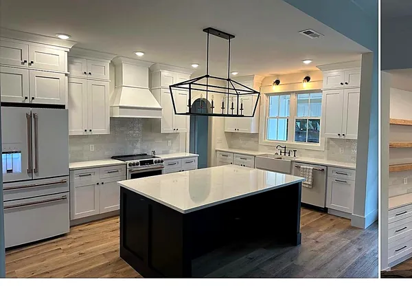 white kitchen with navy island and linear chandelier by WoodArt Cabinets San Antonio